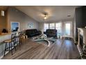 Open-concept living room features vaulted ceilings, hardwood floors, and ample natural light at 3108 Robins Nest Way, Myrtle Beach, SC 29579