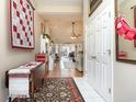 Bright foyer featuring ceramic tile floors, decorative rug, and view to living room at 3178 River Bluff Ln., Little River, SC 29566