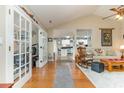 Inviting living room with hardwood floors, vaulted ceilings, and an open view into kitchen at 3178 River Bluff Ln., Little River, SC 29566