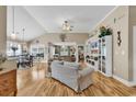 Open living space with hardwood flooring, vaulted ceilings, and views into the adjacent dining area at 322 Crooked Oak Dr., Pawleys Island, SC 29585