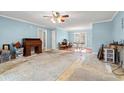 Bright, spacious living room with light blue walls and hardwood flooring transitioning to laminate at 3471 Spivey St., Loris, SC 29569