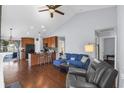 Open-concept living room features vaulted ceilings, hardwood floors and comfortable blue sofa seating at 351 Stafford Dr., Myrtle Beach, SC 29579