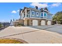 Spacious four-car garage beneath a charming home featuring a raised foundation and lovely blue siding at 3567 Marion Ln., Murrells Inlet, SC 29576