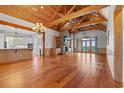 Open-concept living room with hardwood floors, a brick fireplace, and a waterfront view at 3567 Marion Ln., Murrells Inlet, SC 29576