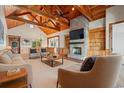 Cozy living room with a brick fireplace, wood ceiling beams, and hardwood floors at 3567 Marion Ln., Murrells Inlet, SC 29576