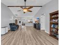 Open concept living area with a ceiling fan, hardwood floors, and lots of natural light at 378 Thistle Ln., Myrtle Beach, SC 29579