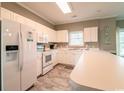 Bright kitchen featuring white cabinetry, modern appliances, and a breakfast bar perfect for casual dining at 4827 Orchid Way # 201, Myrtle Beach, SC 29577