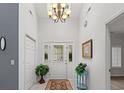 Bright foyer with decorative rug, chandelier and stylishly decorated walls at 4956 Dory Ct., North Myrtle Beach, SC 29582