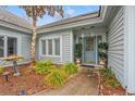 Inviting front entrance featuring decorative plants and a stylish glass-paneled door at 4956 Dory Ct., North Myrtle Beach, SC 29582