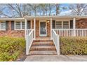 Inviting front porch with brick stairs and white railing at 504 Danner Dr., Conway, SC 29526