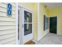 Charming entryway featuring a glass door with a 'Welcome Home' decoration and unit number 101 at 5046 Belleglen Court # 101, Myrtle Beach, SC 29579