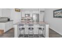 Spacious kitchen island featuring granite countertops and seating, perfect for casual dining and entertaining at 559 Courtridge Loop, Conway, SC 29526