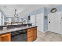 Kitchen with wood cabinetry offering easy access to both the front door and a comfortable living area at 624-B Seabreeze Dr., Garden City Beach, SC 29576