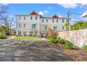 New townhome features a white exterior, well-manicured landscaping, and a private outdoor space with parking at 6606 Wildwood Trail # D, Myrtle Beach, SC 29572