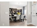 Dining room with elegant chandelier, table for six, and dark wood bookcase for storage at 797 Harrison Mill St., Myrtle Beach, SC 29579