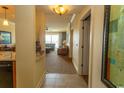 Inviting hallway view leading to a cozy living room with balcony access and comfortable furnishings at 8121 Amalfi Pl. # 4-702, Myrtle Beach, SC 29572