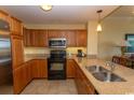 Well-equipped kitchen featuring stainless steel appliances, granite countertops, and ample wooden cabinetry at 8121 Amalfi Pl. # 4-702, Myrtle Beach, SC 29572