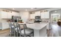 Modern kitchen with stainless steel appliances, white cabinets, and a large center island at 815 Ireland Dr., Longs, SC 29568