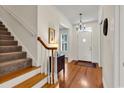 Welcoming foyer with hardwood floors, staircase, and elegant chandelier, creating a warm and inviting entry at 8234 Timber Ridge Rd., Conway, SC 29526