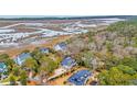 Stunning aerial view showcasing the home's waterfront location and lush surroundings at 830 Channel Cat Cove, Murrells Inlet, SC 29576