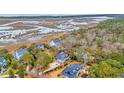 An aerial view shows the neighborhood, wetlands, and the unique marshy waterways at 830 Channel Cat Cove, Murrells Inlet, SC 29576