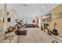 Large, open living room with vaulted ceilings, a fireplace, and lots of natural light at 830 Channel Cat Cove, Murrells Inlet, SC 29576