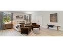 Serene main bedroom with neutral tones, a large bed, sitting area, and ample natural light from two windows at 833 Ireland Dr., Longs, SC 29568