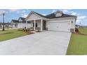 Beautiful home exterior showcasing a long driveway and manicured lawn in a suburban neighborhood at 8713 High Banks Way, Longs, SC 29568