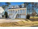 Charming two-story home features double garages and staircase to a covered balcony with lake views at 904 Easton Ct., Myrtle Beach, SC 29579