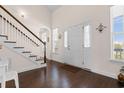 Bright foyer features a white door, gleaming hardwood floors, stairway, and natural light at 904 Easton Ct., Myrtle Beach, SC 29579