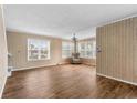Spacious living room featuring wood floors, paneled walls, and multiple windows at 1032 N Ocean Blvd., Surfside Beach, SC 29575