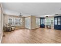 Open concept living room with wood floors, paneled walls, natural light, and stylish blue cabinets at 1032 N Ocean Blvd., Surfside Beach, SC 29575