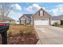 Single-Gathering home with a well-manicured front yard and attached two-car garage at 109 Dry Valley Loop, Myrtle Beach, SC 29588