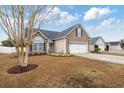 Single-Gathering home with a well-manicured front yard and attached two-car garage at 109 Dry Valley Loop, Myrtle Beach, SC 29588