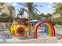 Fun splash pad with colorful play structures and tropical palm trees in a secure environment at 1105 S Ocean Blvd. # 1134, Myrtle Beach, SC 29577