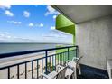 Balcony overlooking the ocean with white chairs and a blue railing and an open, airy ambiance for relaxation at 1105 S Ocean Blvd. # 732, Myrtle Beach, SC 29577