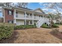 Two-story condo building with white railings and front lawn area at 1250 River Oaks Dr. # 16B, Myrtle Beach, SC 29579