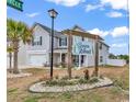 Welcoming Sierra Woods entrance with lush landscaping and attractive signage at 145 Bendick Ct., Little River, SC 29566