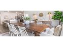 Open concept dining room next to kitchen featuring a large wooden table with seating for six at 1461 Nokota Dr., Conway, SC 29526