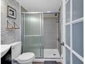 Bathroom featuring decorative wallpaper, walk-in shower, modern fixtures, and a white porcelain toilet at 1605 S Ocean Blvd. # 509, Myrtle Beach, SC 29577