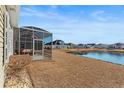 Relaxing backyard with an enclosed patio and serene pond views, perfect for enjoying nature at 1685 Sapphire Dr., Longs, SC 29568