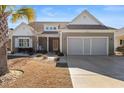 Inviting single-story home featuring a two-car garage, drought-resistant landscaping, and a welcoming entrance at 1685 Sapphire Dr., Longs, SC 29568
