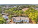 A high angle view showcasing the condo complex near lush woods and a neighborhood in the background at 1849 Crooked Pine Dr. # C-5, Surfside Beach, SC 29575