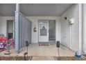 Charming front porch of condo featuring a white door, concrete flooring, and gray fencing at 1849 Crooked Pine Dr. # C-5, Surfside Beach, SC 29575