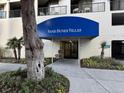 Close up of the entrance to Sand Dunes Villas, showing a blue awning and doorway at 201 N 74Th Ave. N # 2322, Myrtle Beach, SC 29572