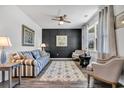 Beautifully staged living room features modern decor, including a stylish sofa and accent wall at 220 Forestbrook Cove Circle, Myrtle Beach, SC 29588