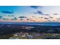 Breathtaking aerial view of a coastal community with waterfront homes and stunning sunset skies at 2226 Seagrape Dr., Little River, SC 29566
