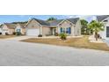 Charming single-story home featuring a well-manicured lawn, tidy landscaping, and an attached two-car garage at 224 Cupola Dr., Longs, SC 29568
