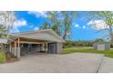 The home's carport features a stained wood ceiling, storage area, and spacious concrete pad at 2360 Highway 701 North, Loris, SC 29569