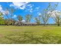 A serene view of the home exterior showcasing its large yard and covered porch at 2360 Highway 701 North, Loris, SC 29569